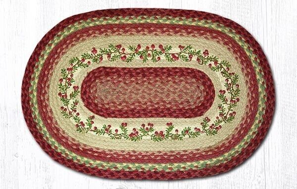 a red and white oval rug on top of a wooden floor next to a wall