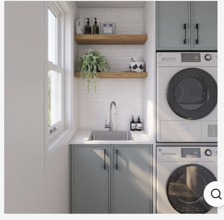 there is a washer and dryer in this small laundry room with open shelving