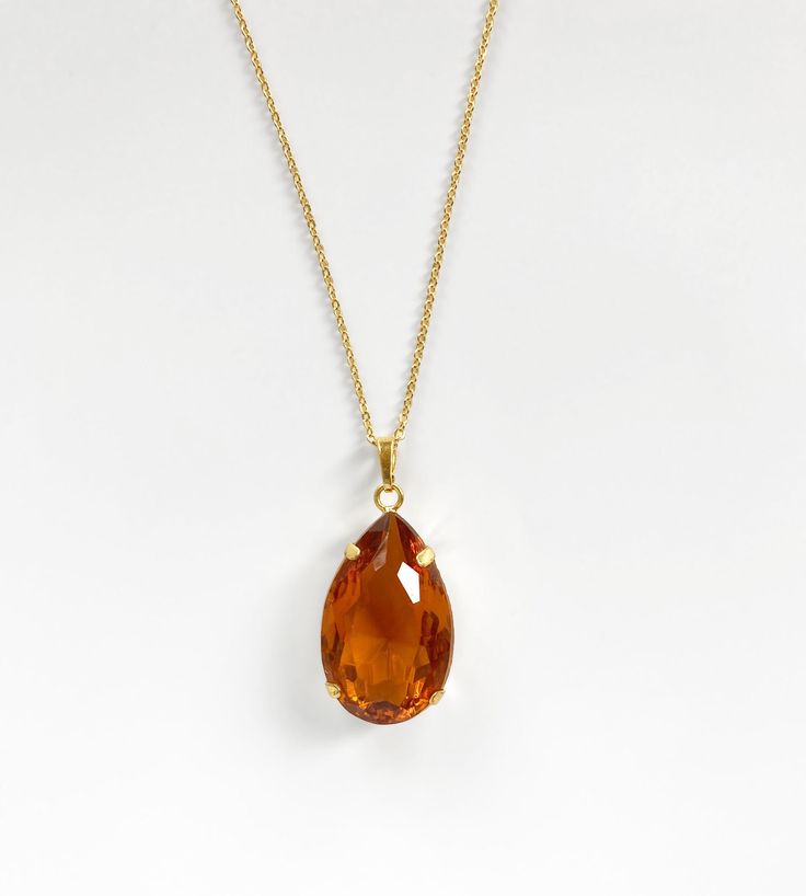 "A gorgeous chunky glass pendant necklace which dates to the 1980s. The beautifully faceted drop is a scarlet shade of red - in some lights it has a hint of orange. The total drop of the pendant from the top of the bail (loop) is 1.7\"= 4.5cm. The glass stone alone measures 1.3\" x 0.8 inches = 3cm x 2cm. Choose from 16 inch or 22 inch chain. The bail is large and can easily be opened allowing you to thread it onto an alternative necklace or cord. Other colours listed separately. The necklaces a Handmade Orange Teardrop Necklace, Orange Teardrop Citrine Jewelry, Orange Gemstone Vintage Necklaces, Vintage Orange Gemstone Necklaces, Orange Gemstone Pendant Necklace, Black Gold Necklace, Vintage Gold Brooch, Blue Topaz Pendant Necklace, Gold Drop Necklace