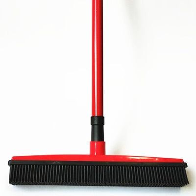 a red broom with black handle on a white background