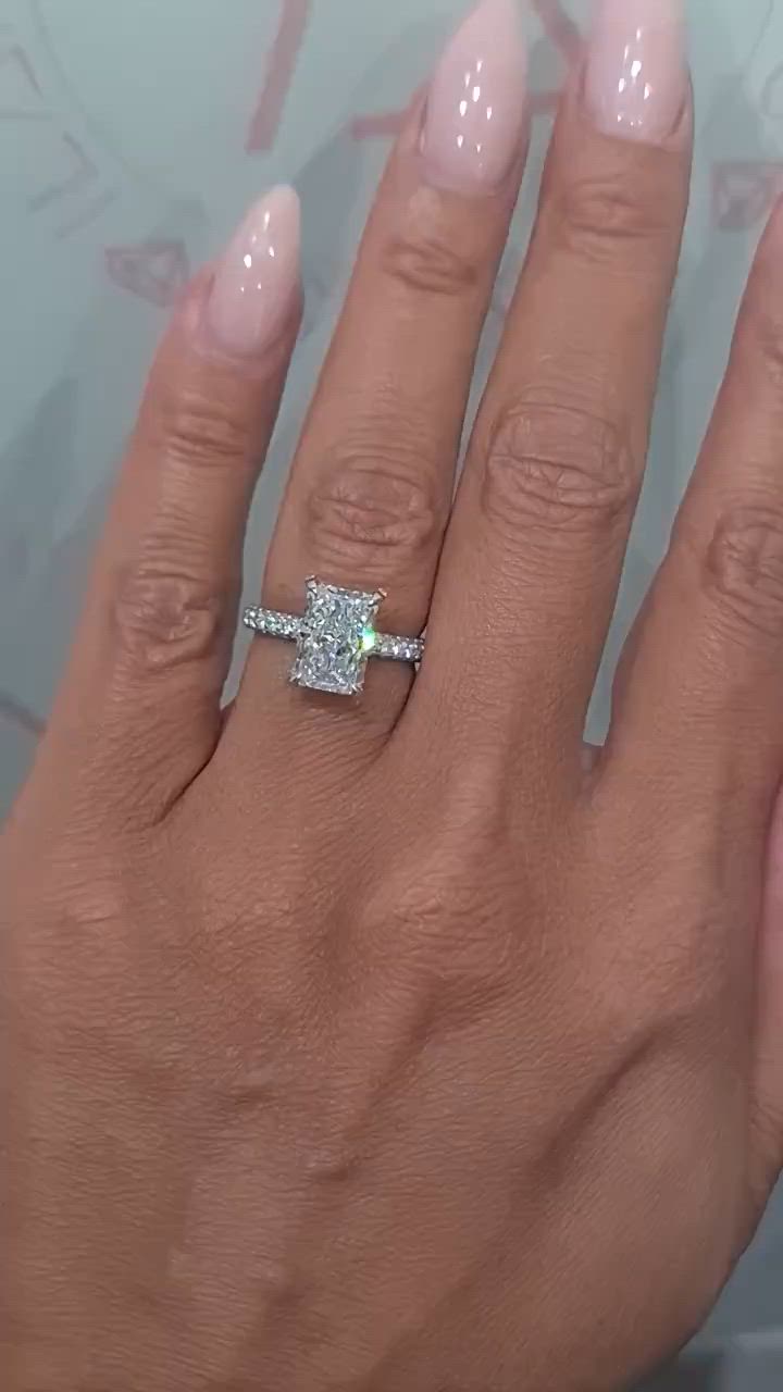 This may contain: a woman's hand with a diamond ring on it