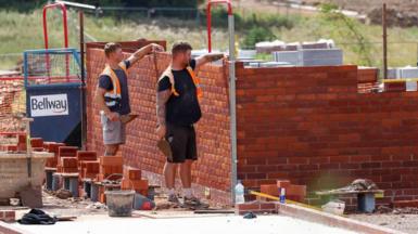 Bricklayers building a house