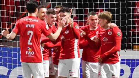 Larne players celebrate after going 1-0 in front 40 seconds into the second half