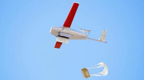 A drone with a little parachute dropping away from it 