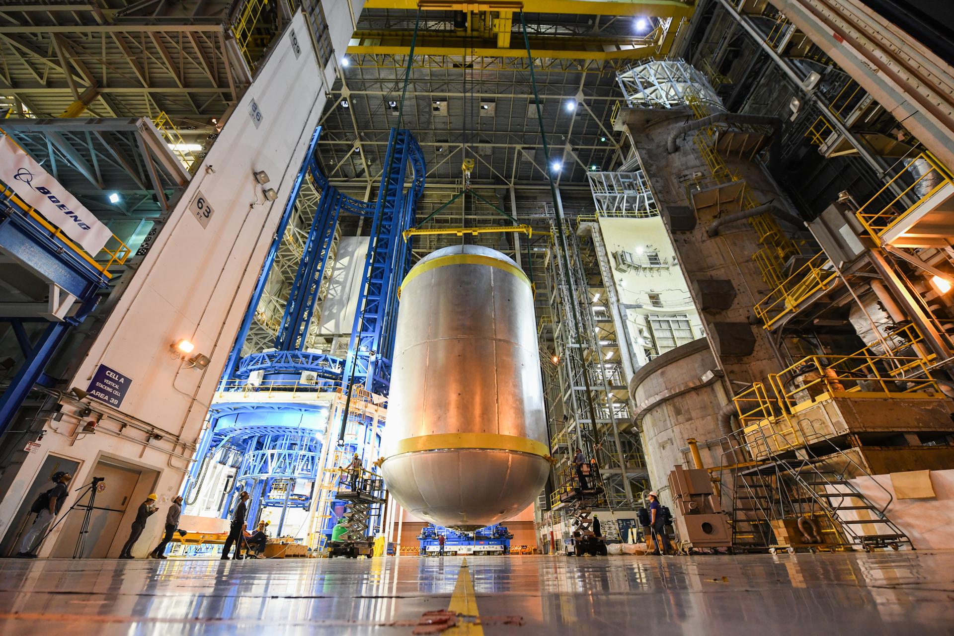 This image shows the latest progress NASA has made in manufacturing the liquid oxygen tank for the second core stage of NASA’s Space Launch System (SLS) rocket. The liquid oxygen tank will be used for the first crewed mission, Artemis II, of the agency’s Artemis program. Teams at NASA’s Michoud Assembly Facility in New Orleans recently completed internal cleaning of the liquid oxygen, or LOX, tank at the facility. Following the cleaning, crews prepared the propellant tank for the next phase of phase of assembly in a different area of the factory by moving, or breaking over, the tank from a vertical to horizontal position. The LOX tank is one of five major elements that make up the rocket’s massive 212-foot-tall core stage. The propellant tank holds 196,000 gallons of supercooled liquid oxygen to help fuel four RS-25 engines, and the internal cleaning ensures no contaminants make their way into the complex propulsion and engine systems of the deep space rocket. The stage, which includes a cluster of four RS-25, will produce more than 2 million pounds of thrust to help launch the SLS rocket and astronauts aboard NASA’s Orion spacecraft around the Moon for Artemis II.   NASA is working to land the first woman and the next man on the Moon by 2024. The agency’s SLS rocket offers more payload mass, volume capability and energy to speed missions through deep space and enable NASA’s Artemis lunar program. SLS, along with Orion, the human landing system, and the Gateway in orbit around the Moon are NASA’s backbone for deep space exploration. No other rocket is capable of carrying astronauts in Orion around the Moon in a single mission.