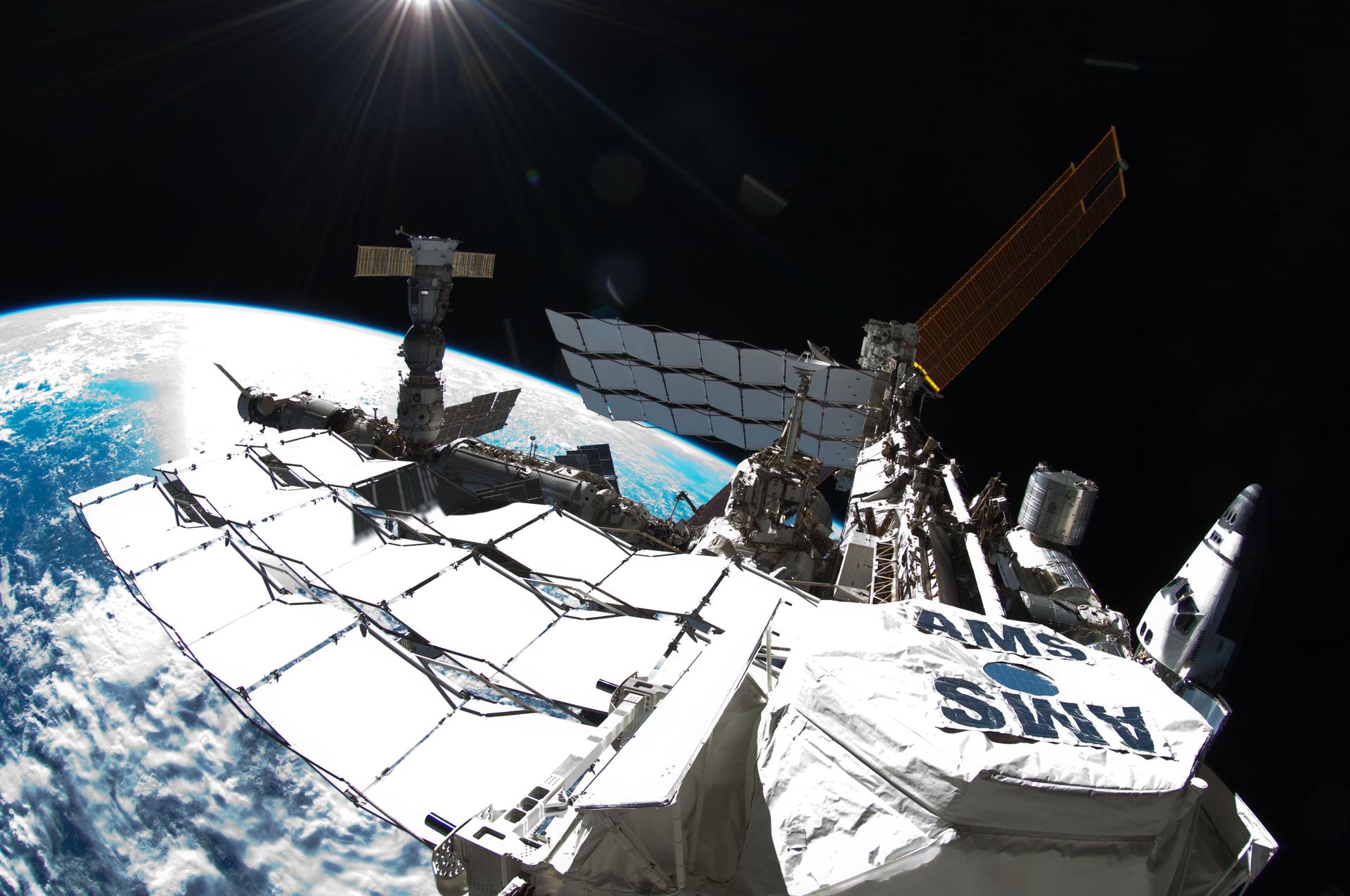 Photo of exterior view of the International Space Station, taken by NASA astronaut Ron Garan during a spacewalk conducted on July 12, 2011. The photo shows the space station with a Fisheye Camera and the curvature of Earth below.