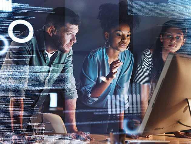 Three colleagues reviewing data together 