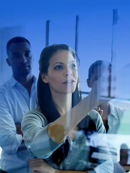 Woman pointing at image with colleagues beside her