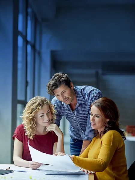 Three colleagues reviewing documents