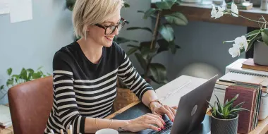 Female author working at home on laptop