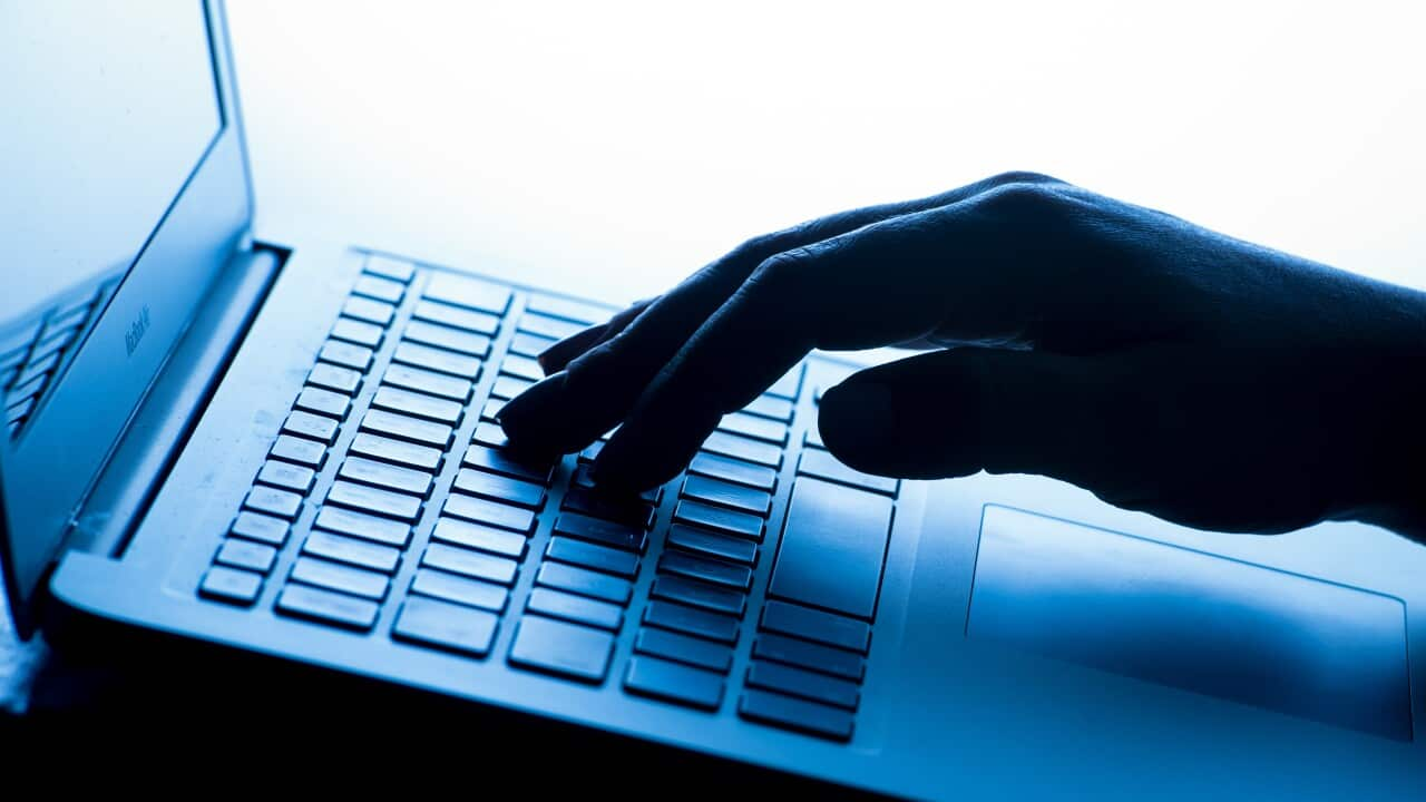 Close up of a person's hands typing on a laptop