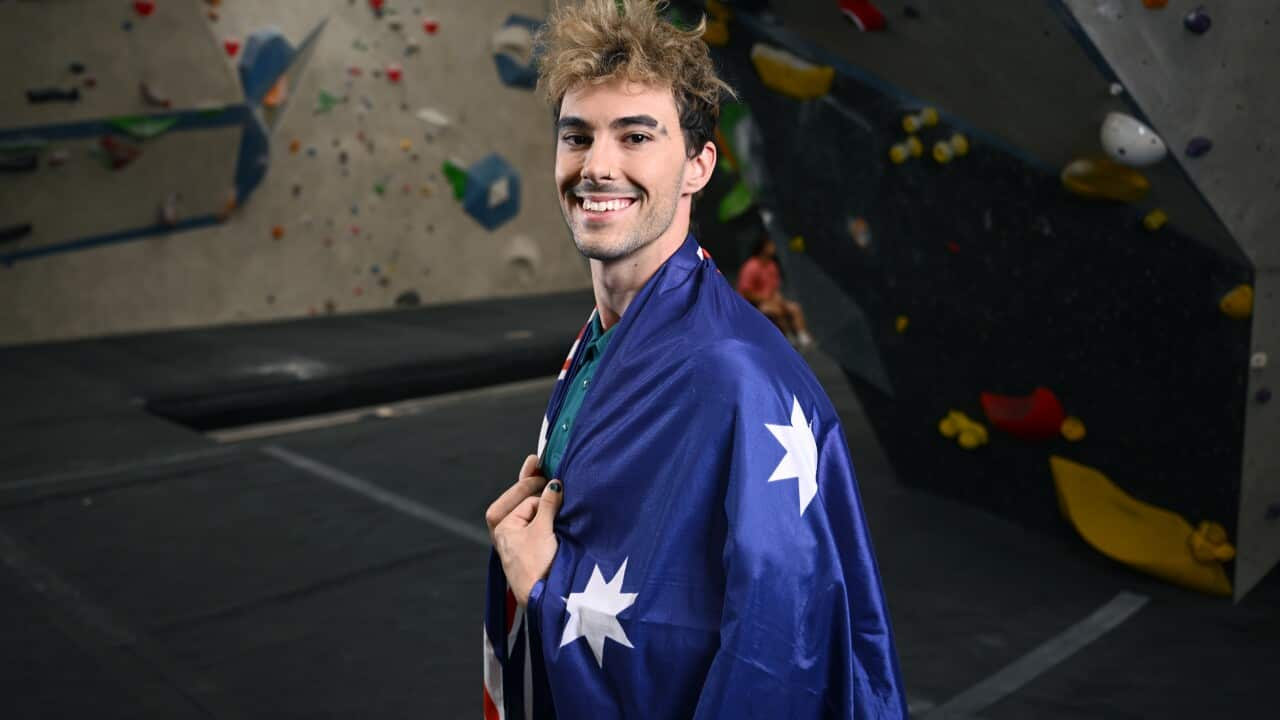 A man with an Australian flag draped over his shoulders.