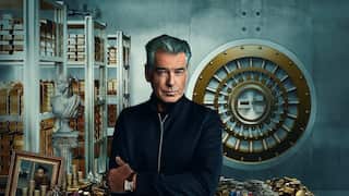 A composite artwork shows Pierce Brosnan against a backdrop of gold bars, money and artworks. 
