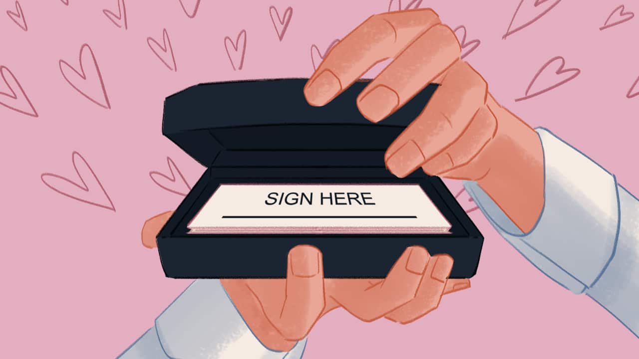 A cartoon image of two hands gripping a wedding ring box - inside it contains a small form that reads "sign here"