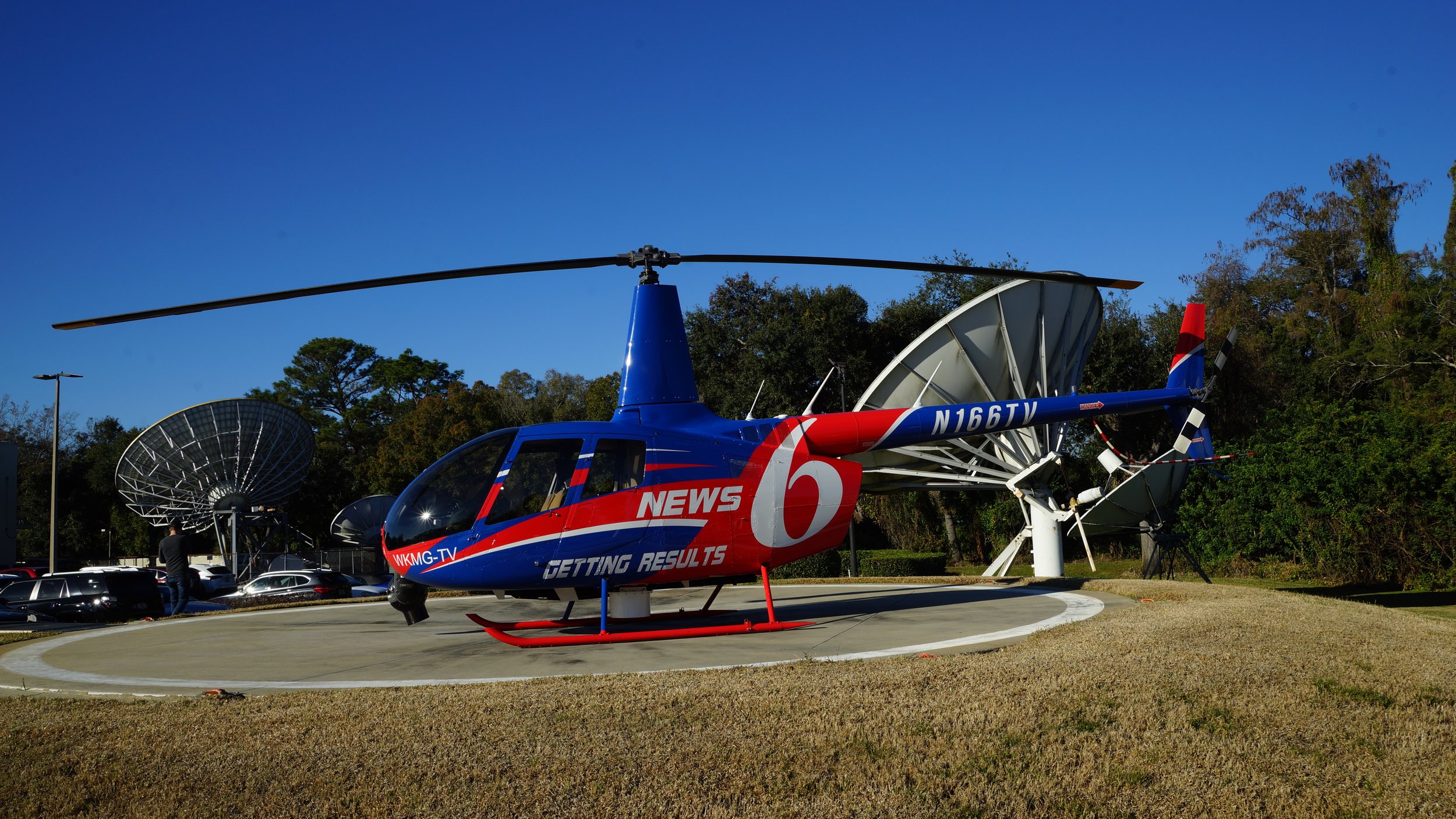 News 6 helicopter with satellite dishes in the background