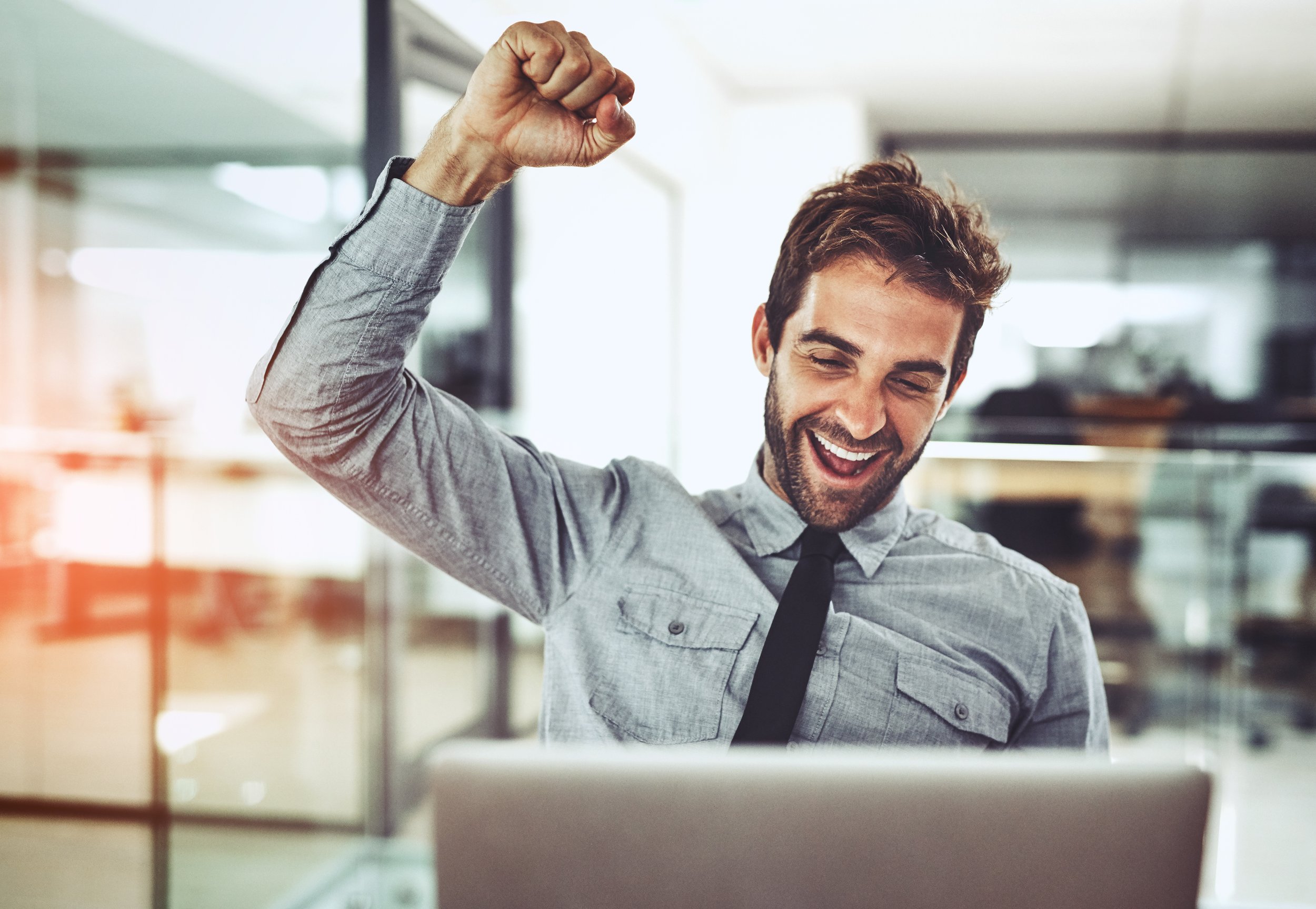 A man fist pumping the air in excitement