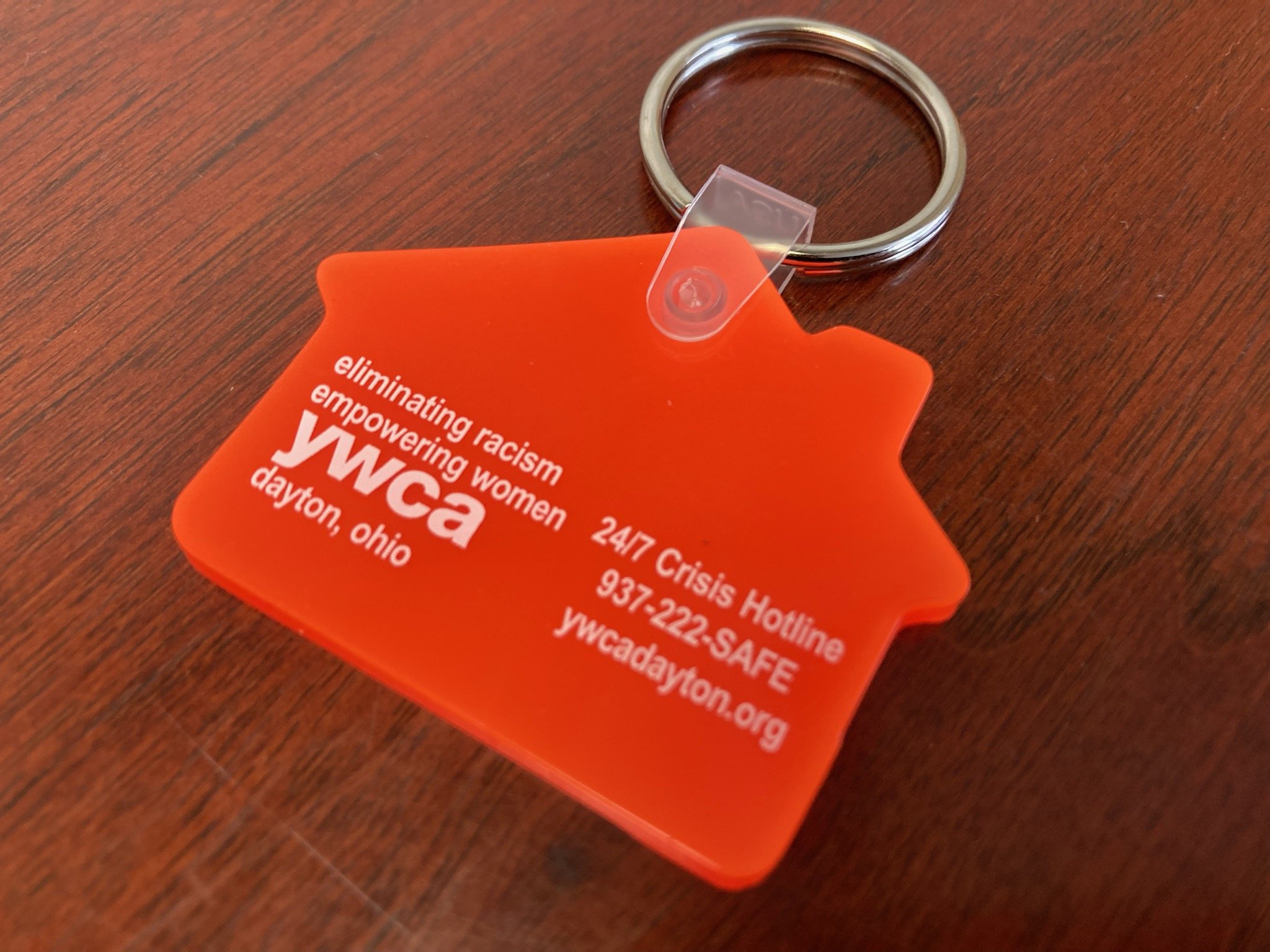 orange silicone house shaped keychain charm with the ywca, survivor services, YWCA DAYTON dayton logo