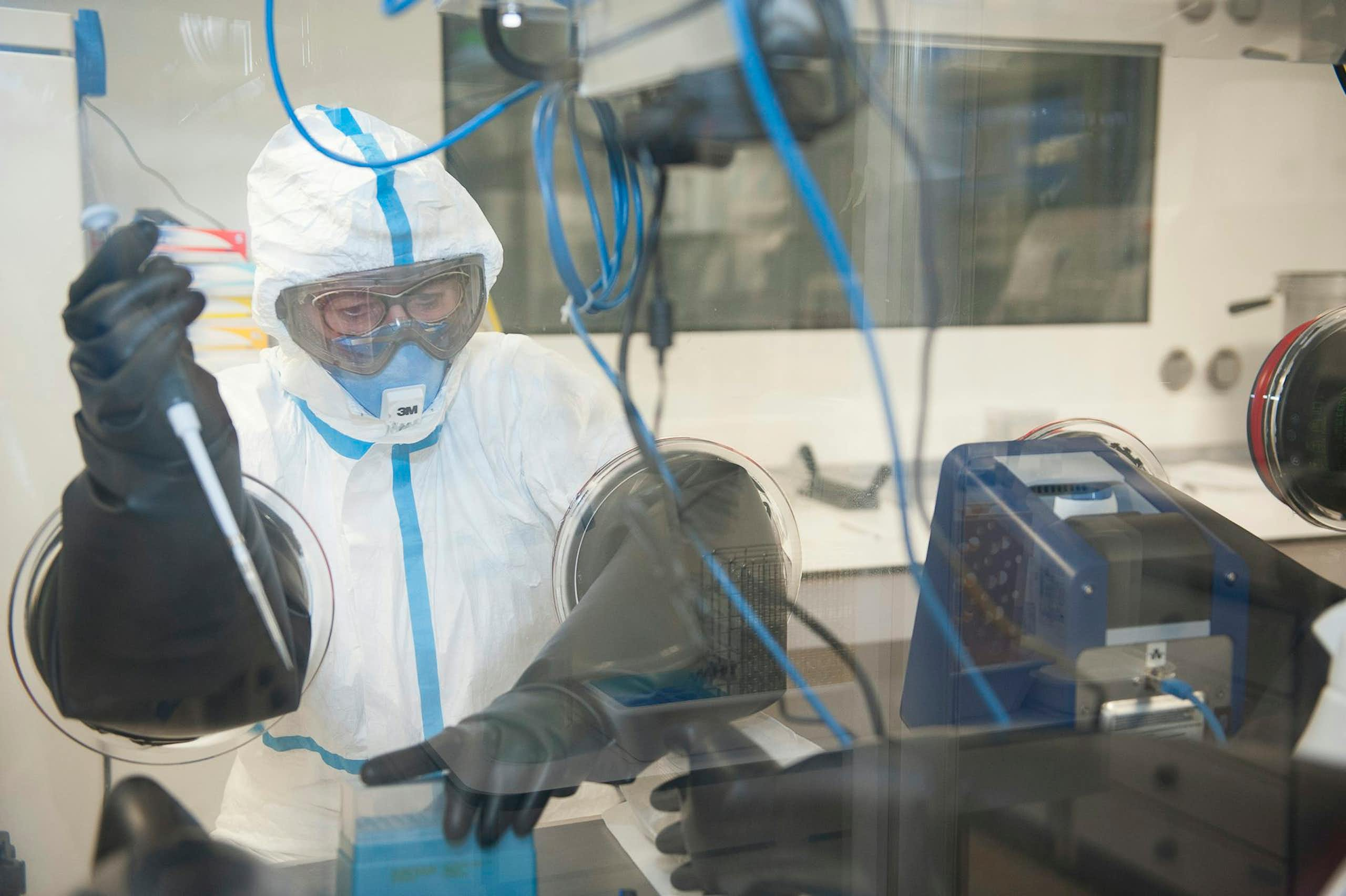 Dans le laboratoire du CHU de Rouen, un opérateur est revêtu d'un équipement de protection individuelle spécifique pour assurer sa sécurité.