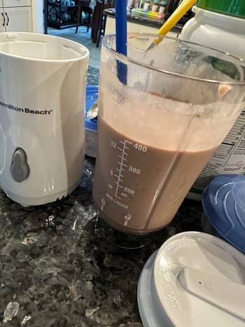 Blender with smoothie mix on kitchen counter next to a Hamilton Beach appliance