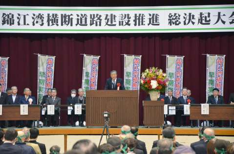 錦江湾横断道路推進の決起大会であいさつする自民党の森山裕幹事長（中央）＝１９日、鹿児島市の南栄リース桜島アリーナ