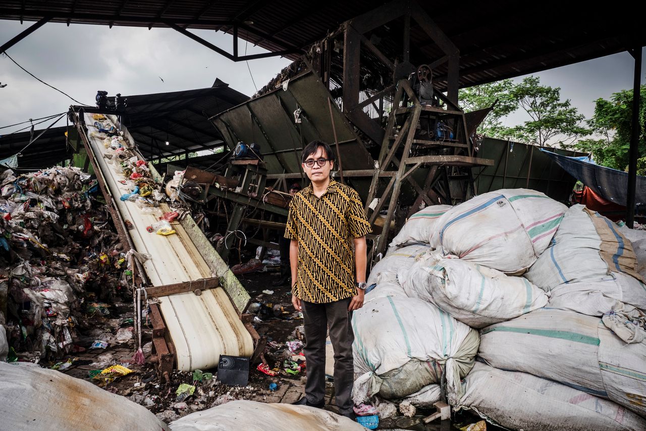 Bhima Diyanto, an ecologist and director of a waste management company, poses at a mechanical sorting center where neighborhood trash can be recycled. 