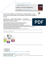 Numerical simulation of the melting of solid paraffin in a solar water heater and the effect of the number of fins and the height of the fins