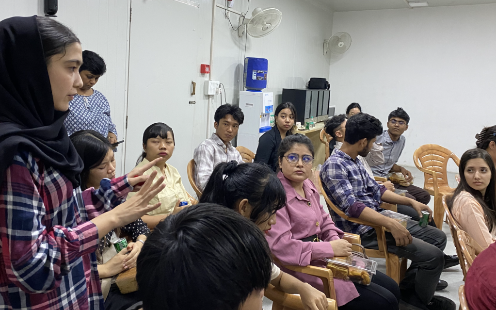 A young woman gestures while speaking as a group of refugees and asylum seeker youth look on during an interaction with United Nations in India Resident Coordinator Shombi Sharp at the UNHCR registration facility in New Delhi.  #WithRefugees #DignityForAll #YouthEmpowerment #GlobalGoals 