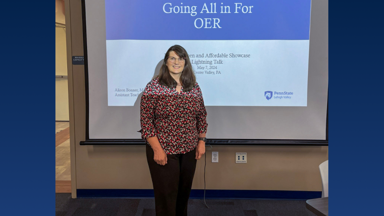 a female professor smiling in front of a classroom 