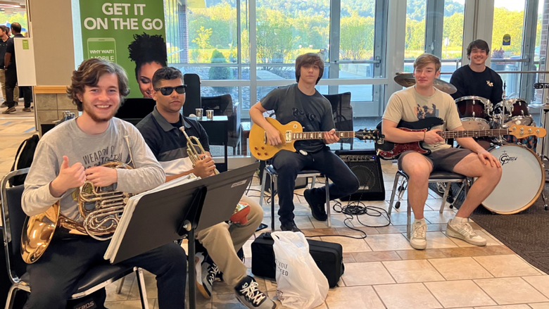 a group of male students playing instruments 