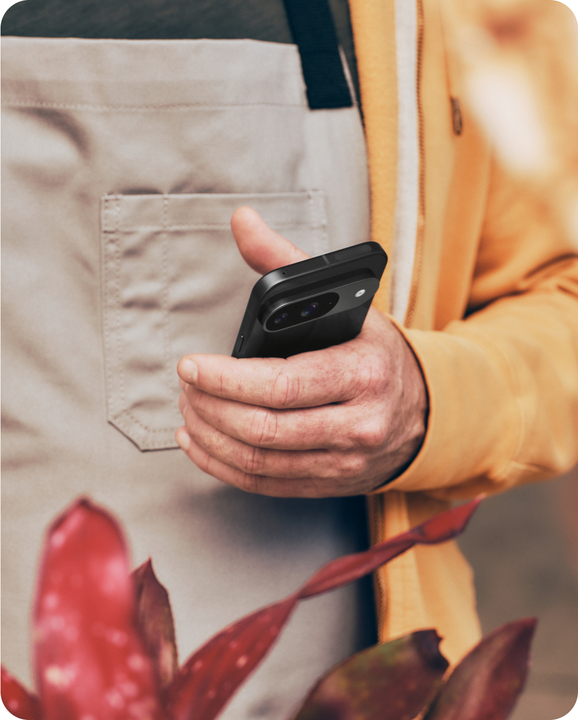 A man using his Google Pixel 9 phone at his flower shop.