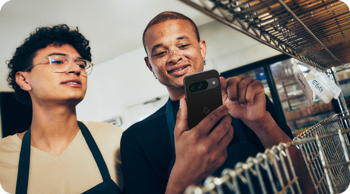 Two employees using a Pixel 9 in a bakery.