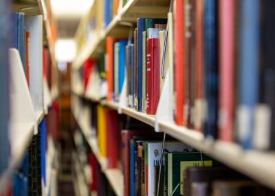 View down the aisle between parallel bookshelves