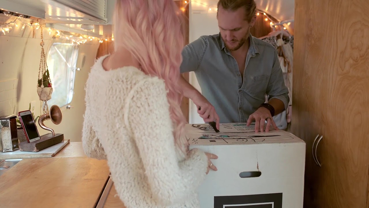 A woman and man unboxing a lull.