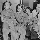 Joan Blondell, Dick Powell, Ellen Powell, and Norman S. Powell