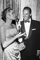 Best Actress Grace Kelly (The Country Girl) with presenter William Holden at the 27th Academy Awards.