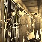 Lyle Talbot (with gun) and Spencer Tracy during prison break scene in "20,000 Years in Sing Sing" (1932)