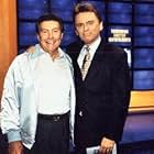 Johnny Gilbert and Pat Sajak in Jeopardy! (1983)