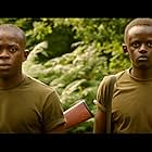 Isaac Ssebandeke and John Kamau in Columbite Tantalite (2013)