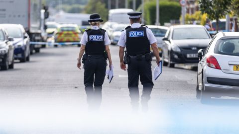 Police officers near the scene in Hart Street, Southport, where the attack took place.