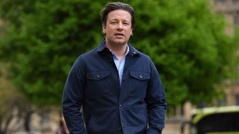 British chef and activist Jamie Oliver arrives to speak to members of the media after speaking on the subject of childhood obesity at Parliament&apos;s Health and Social Care Committee in London on May 1, 2018. (Photo by Ben STANSALL / AFP)        (Photo credit should read BEN STANSALL/AFP/Getty Images)