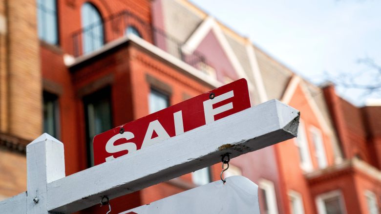 A For Sale sign is displayed in front of a house in Washington, DC, on March 14, 2022. 