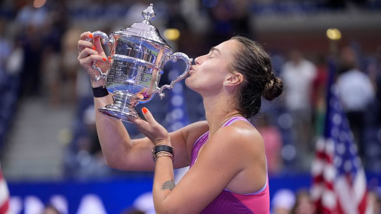 Aryna Sabalenka, of Belarus, kisses the trophy after winning the women&apos;s singles final of the U.S. Open tennis championships against Jessica Pegula, of the United States, , Saturday, Sept. 7, 2024, in New York. (AP Photo/Frank Franklin II)