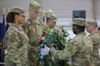 U.S. Army Col. Matthew Hill, center-left, 11th Expeditionary Combat Aviation Brigade (ECAB) commander, receives a wreath from 1st Lt. Aaron Simpson, right, with Area Support Group – Kuwait, during a ceremony at Camp Buehring, Kuwait, May 30, 2022. The commanding officers and command sergeants major of Base Support Battalion – Kuwait and the 11th ECAB hosted the Memorial Day ceremony to pay respects to the origins of the federal holiday and continue the tradition of wreath-laying to honor fallen service members. (U.S. Army photo by Spc. Zachary Danaher)