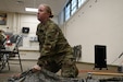 U.S. Army Reserve Sgt. Lindsey Steward, a medic with the 490th Chemical Battalion, prepares to demonstrate how to utilize two poles to create a make-shift liter for transport of an injured Soldier during Combat Lifesaver training at the Horace B. Hanson Army Reserve Center in Birmingham, Alabama December 14, 2022. Training such as this emphasizes emergency medical attention during combat operations. (U.S. Army Reserve photo by Sgt. John W. Todd)