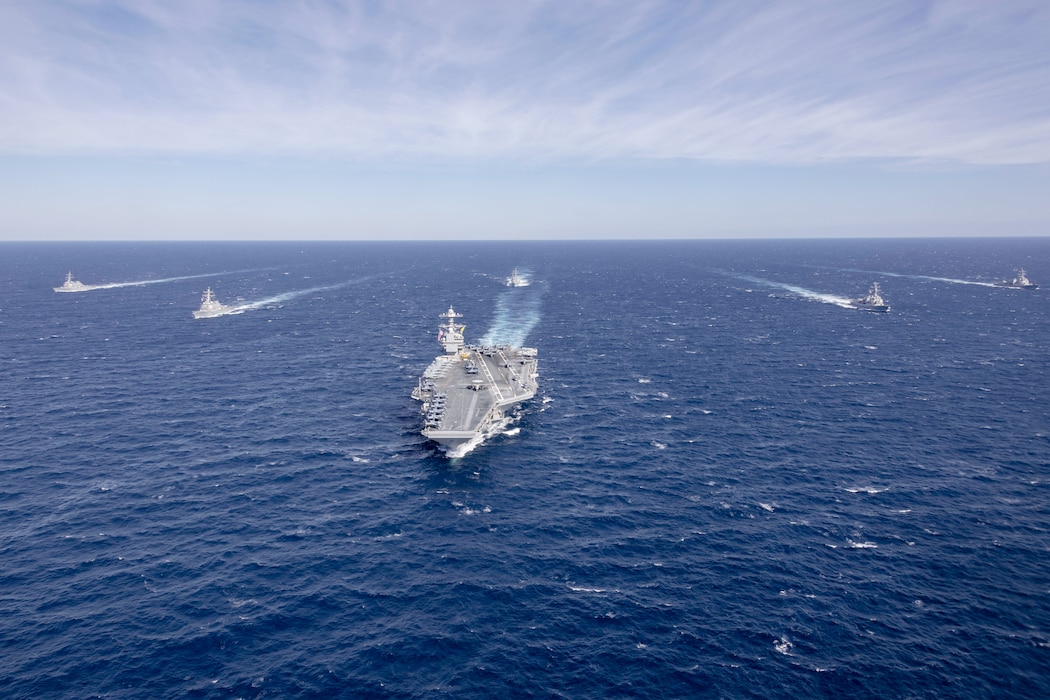 USS Gerald R. Ford (CVN 78) sails in formation with USS Winston Churchill (DDG 81), USS Mitscher (DDG 57), USS Mahan (DDG 72), USS Bainbridge (DDG 96), and USS Forrest Sherman (DDG 98) in the Atlantic Ocean.