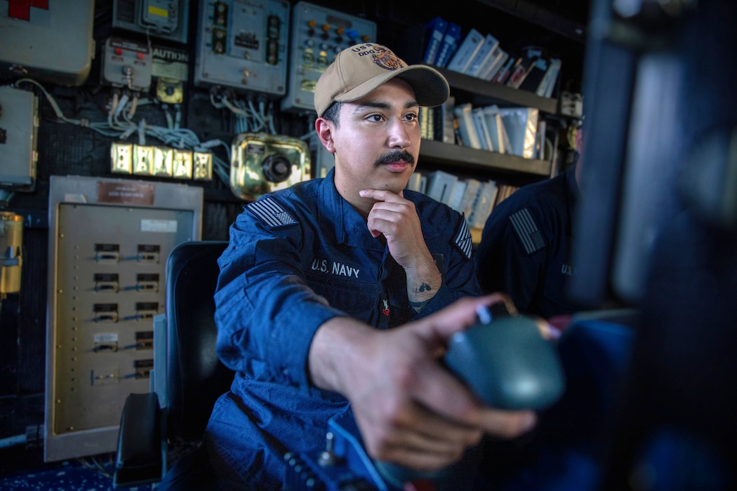 A fire controlman stands watch on the bridge aboard USS Cole (DDG 67) in the U.S. Central Command area of responsibility.