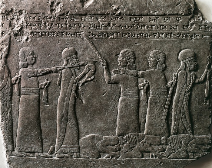 Close-up of a relief depicting Babylonian prisoners paying homage to king Ashurbanipal and his queen