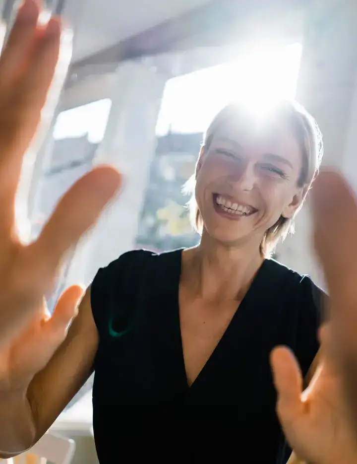 Female and male giving each other high five in an office