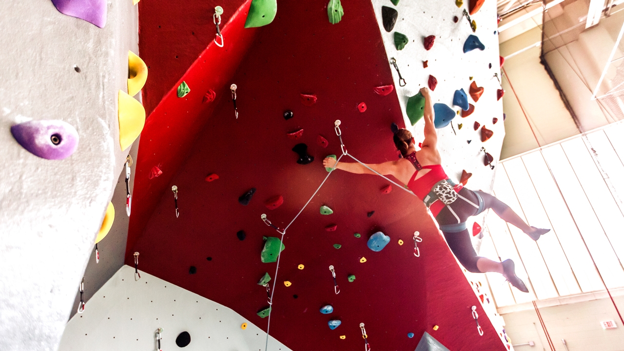 student on a climbing wall