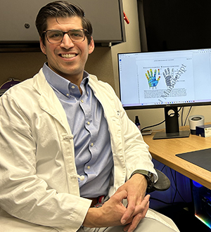 Daniel Kramer, MD, in an office with computer monitors